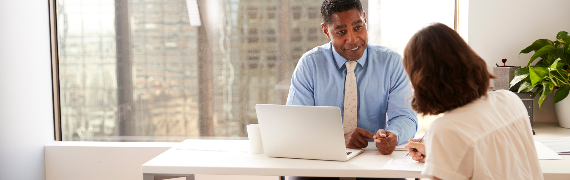 Businesswoman consults clients over a virtual meeting.