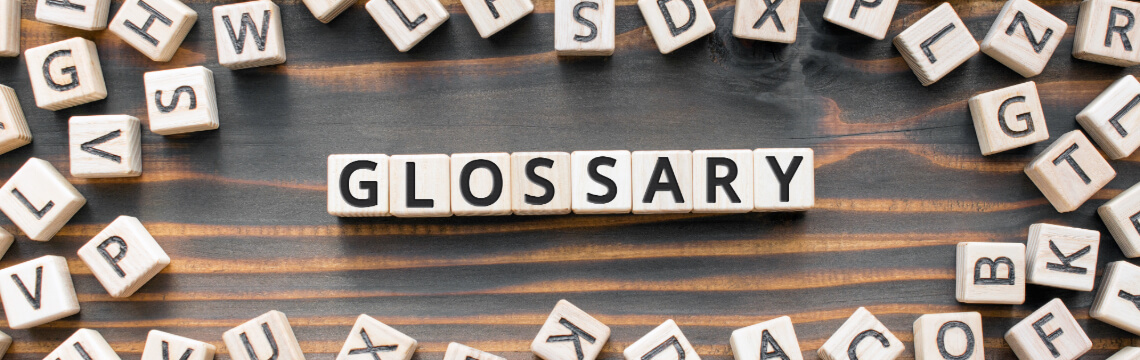 The word glossary spelled out with scrabble pieces 