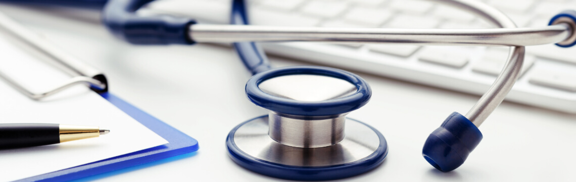 Stethoscope and keyboard sitting on a desk