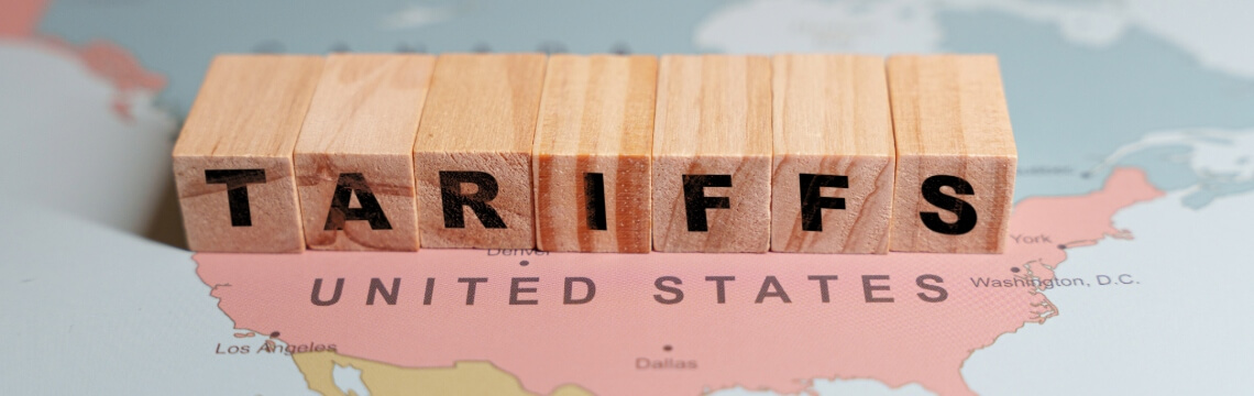 Wooden blocks spelling Tariffs on map of North America.