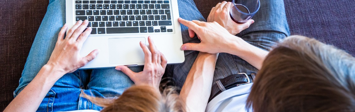 people-looking-at-online-travel-agency-website-on-laptop